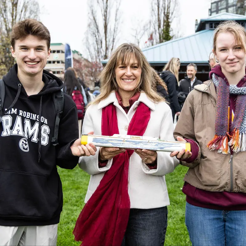 Student speakers Kallem Manning and Griffin Dekker stand with Burlington Mayor Marianne Meed Ward and the King's Baton