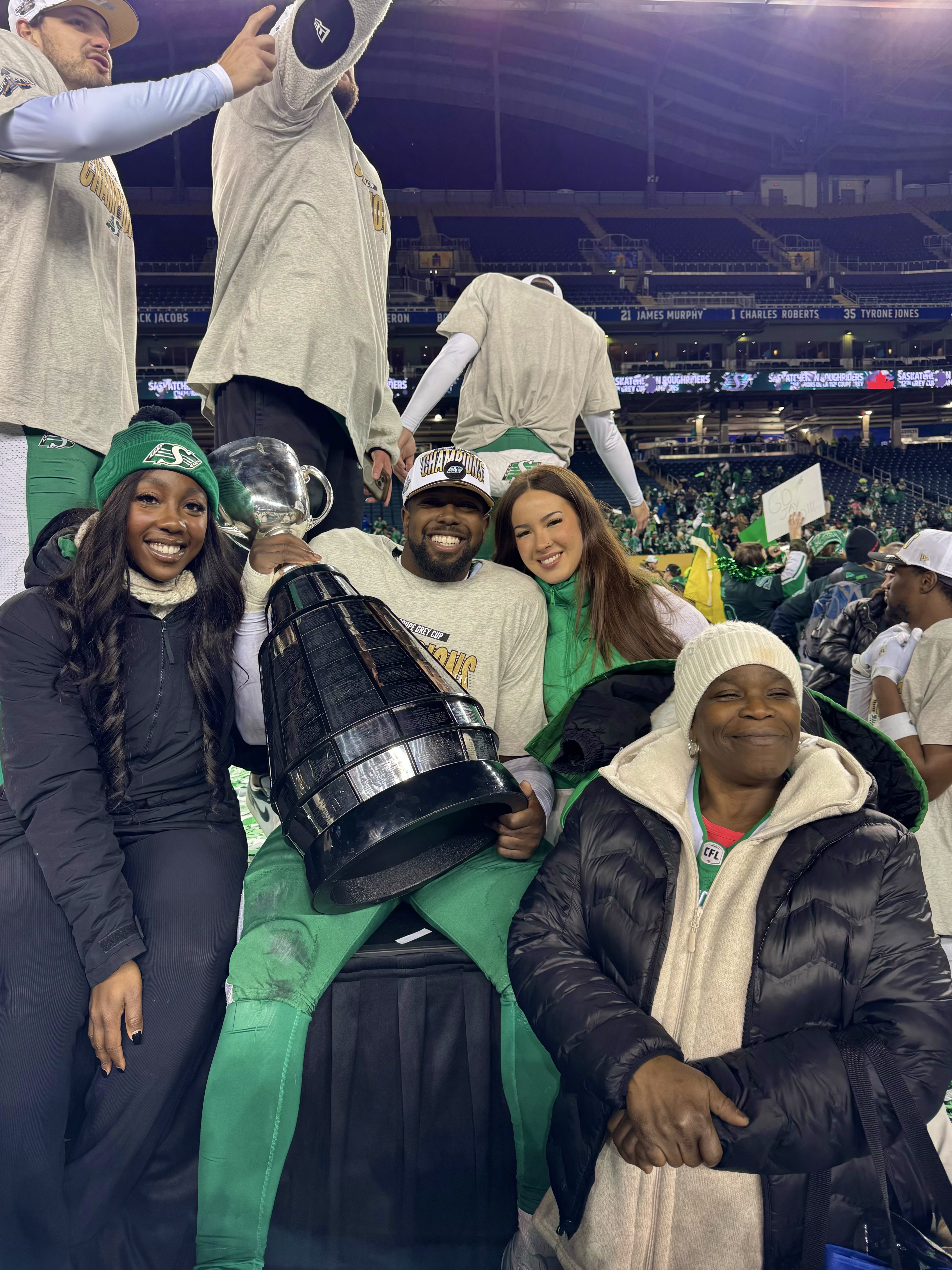 AJ Allen holding the Grey Cup