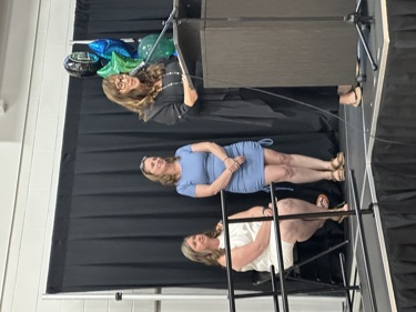 VP Beth McLash speaking at the podium at Graduation.  Also pictured are Shannon Gardi and Lisa Touchings