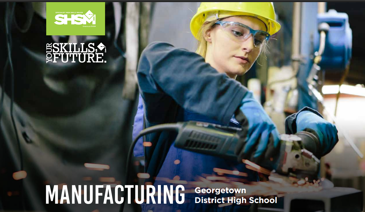 a teenager wearing a yellow hard hat and safety glasses working in an industrial factory setting.