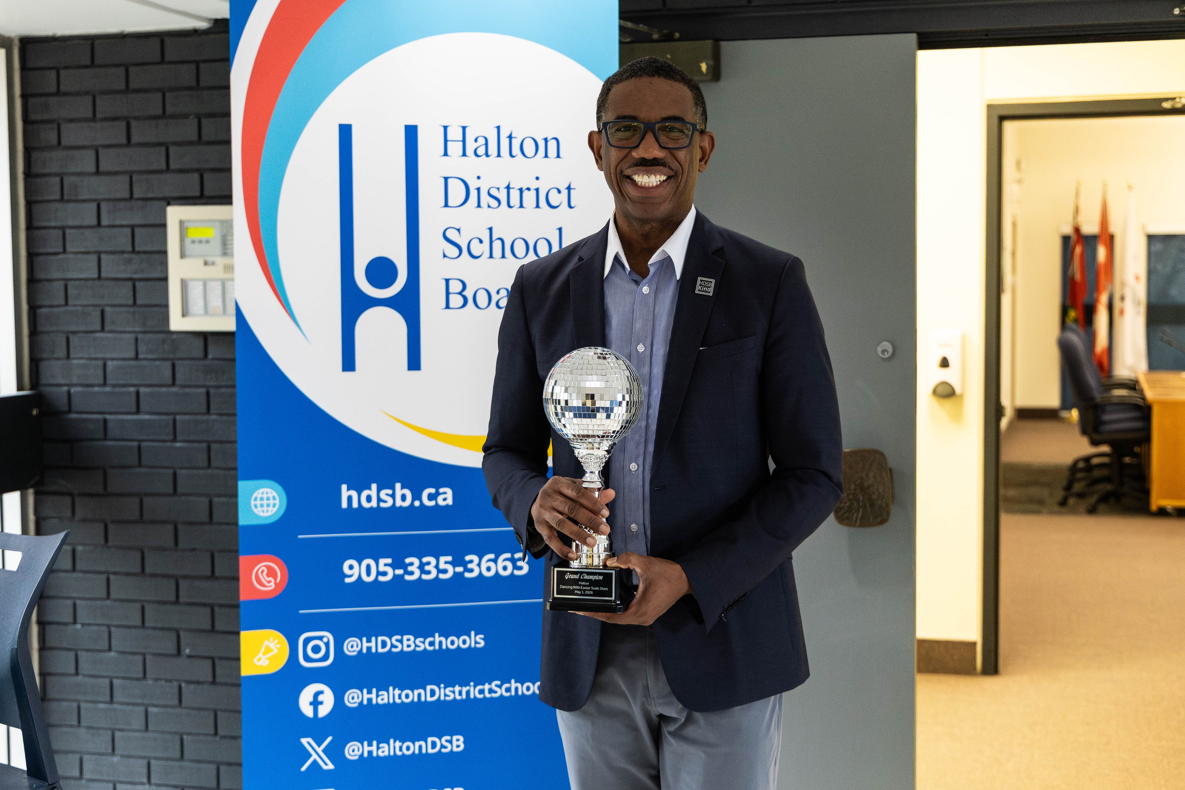 Director Curtis Ennis holding the Dancing with the Easter Seals Stars Grand Champion trophy