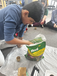 Student planting seeds