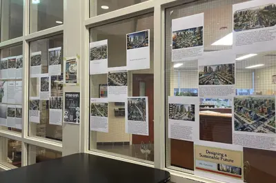 several research papers taped up to a glass window.