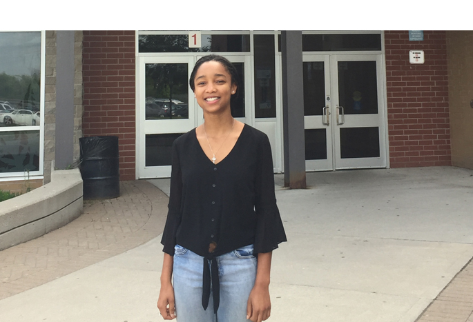 Arielle Ainabe, Grade 12 standing in front of Garth Webb SS