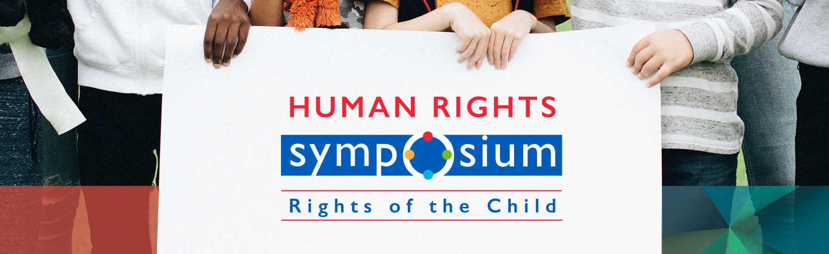 Children holding up a sign in a field with the Halton District School Board Human Rights Symposium logo